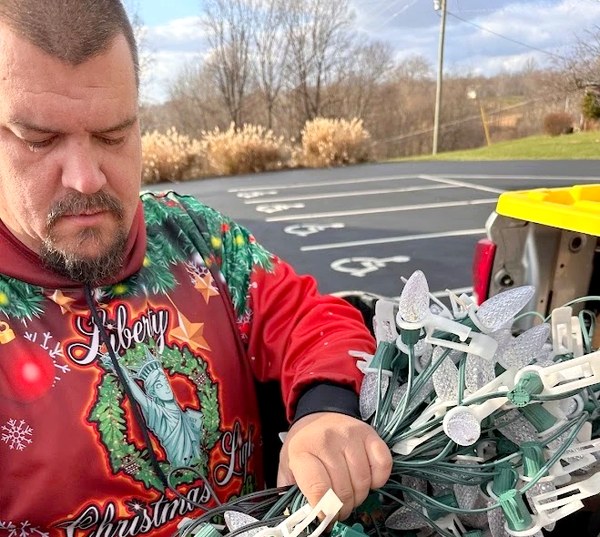 DJ, owner of Liberty Christmas Lights, sorting C9 bulb strands before an install